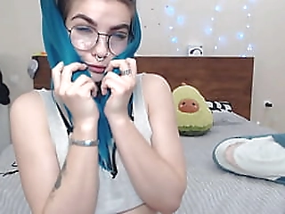 beautiful girl with blue hair playfully sucks a big dildo that cums on her face