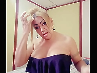 young skinny ladyboy in brown dress strips and jerks off on sofa